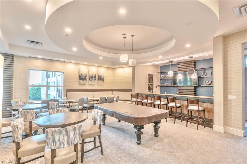 9115 Strada Place, Unit 5317 Naples, FL 34108 - Photo 27 of 30 a room with lots of tables a large window and chairs