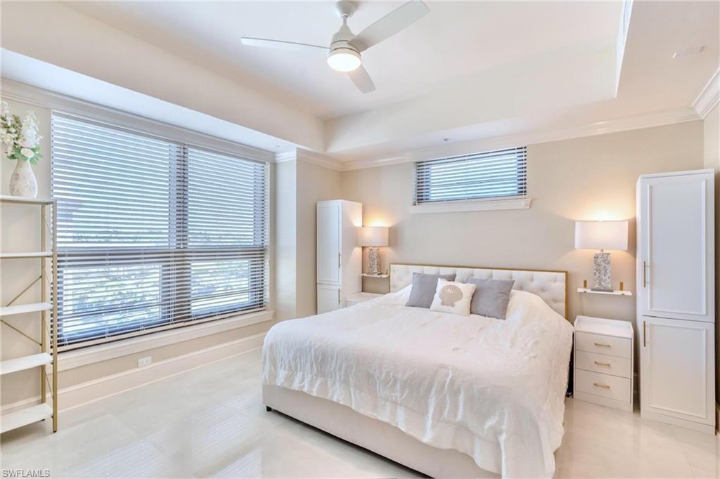 9115 Strada Place, Unit 5317 Naples, FL 34108 - Photo 10 of 30 a bedroom with a large bed and a large window