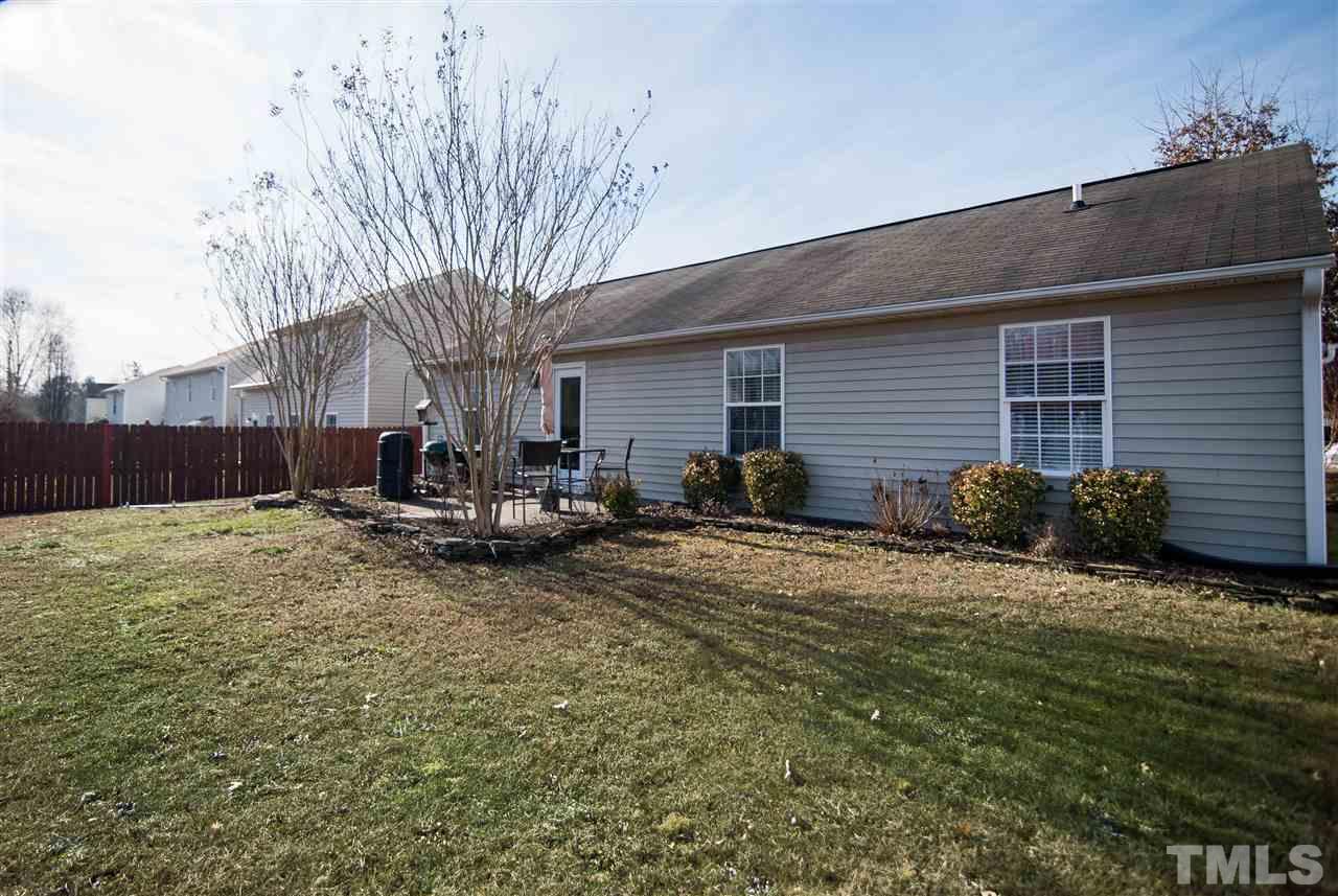 3805 Tyler Bluff Lane Raleigh, NC 27616 - Photo 14 of 15 a view of backyard of house with outdoor seating and green space