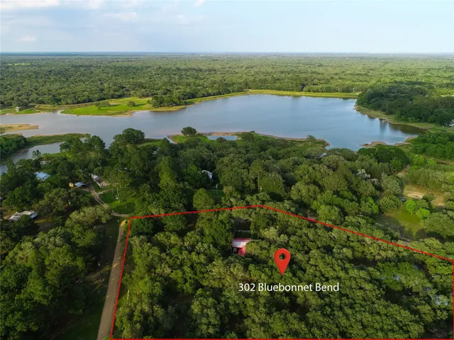 an aerial view of residential houses with outdoor space and swimming pool