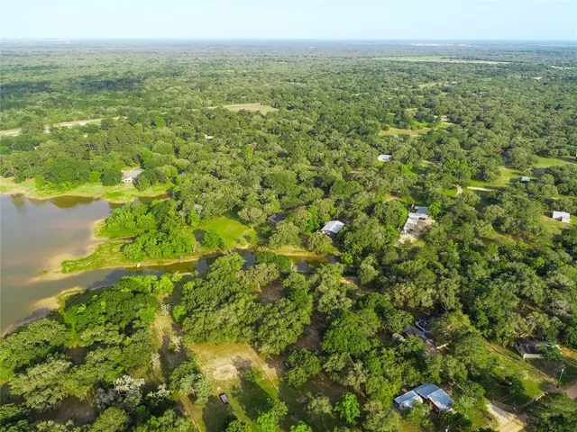 an aerial view of house with yard and mountain view in back