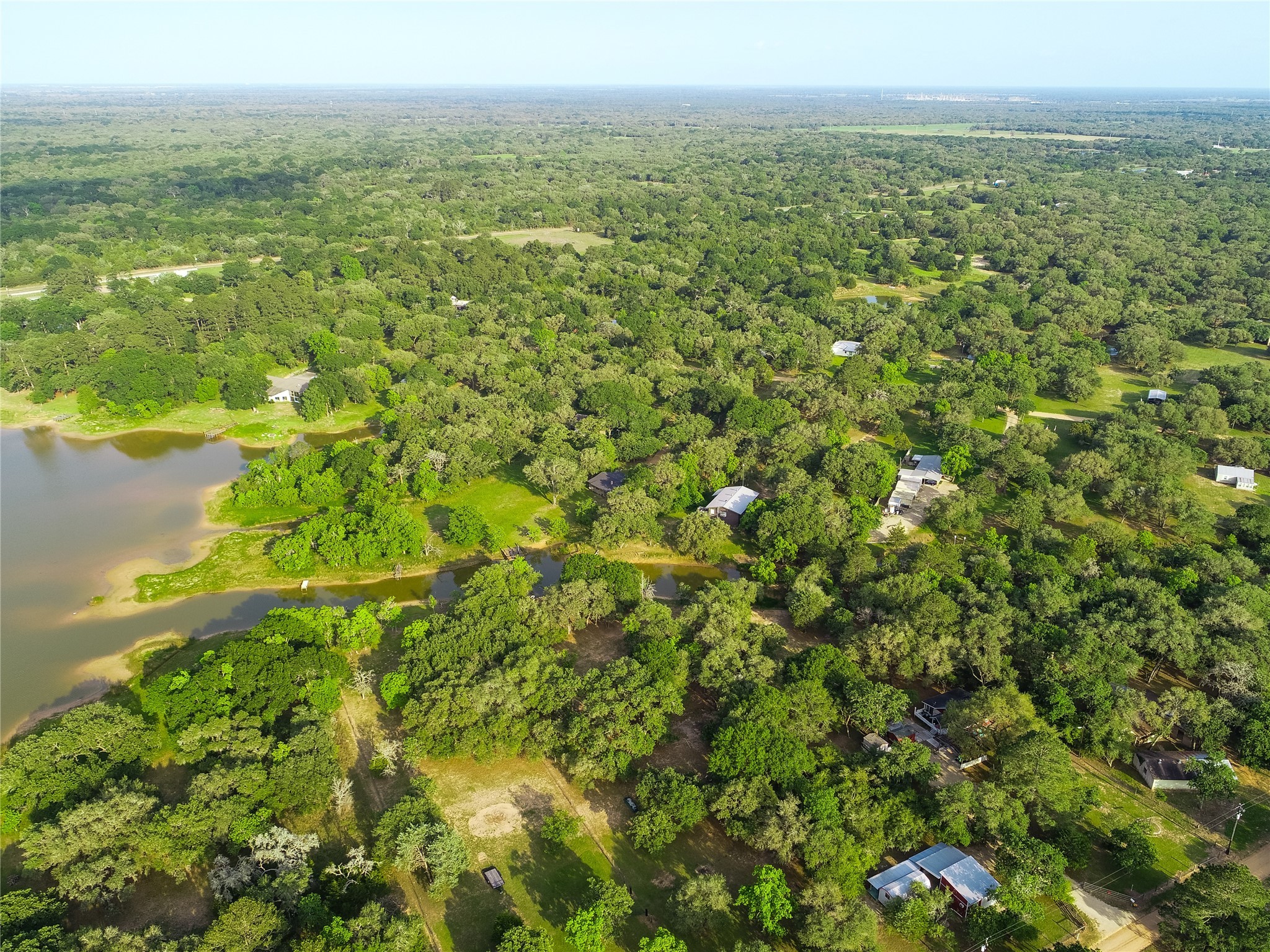 302 Bluebonnet Bend Sheridan, TX 77475 - Photo 13 of 29 a view of a big yard with lots of bushes