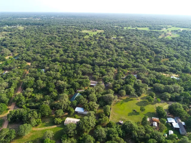 a living room with furniture a chandelier and a large window