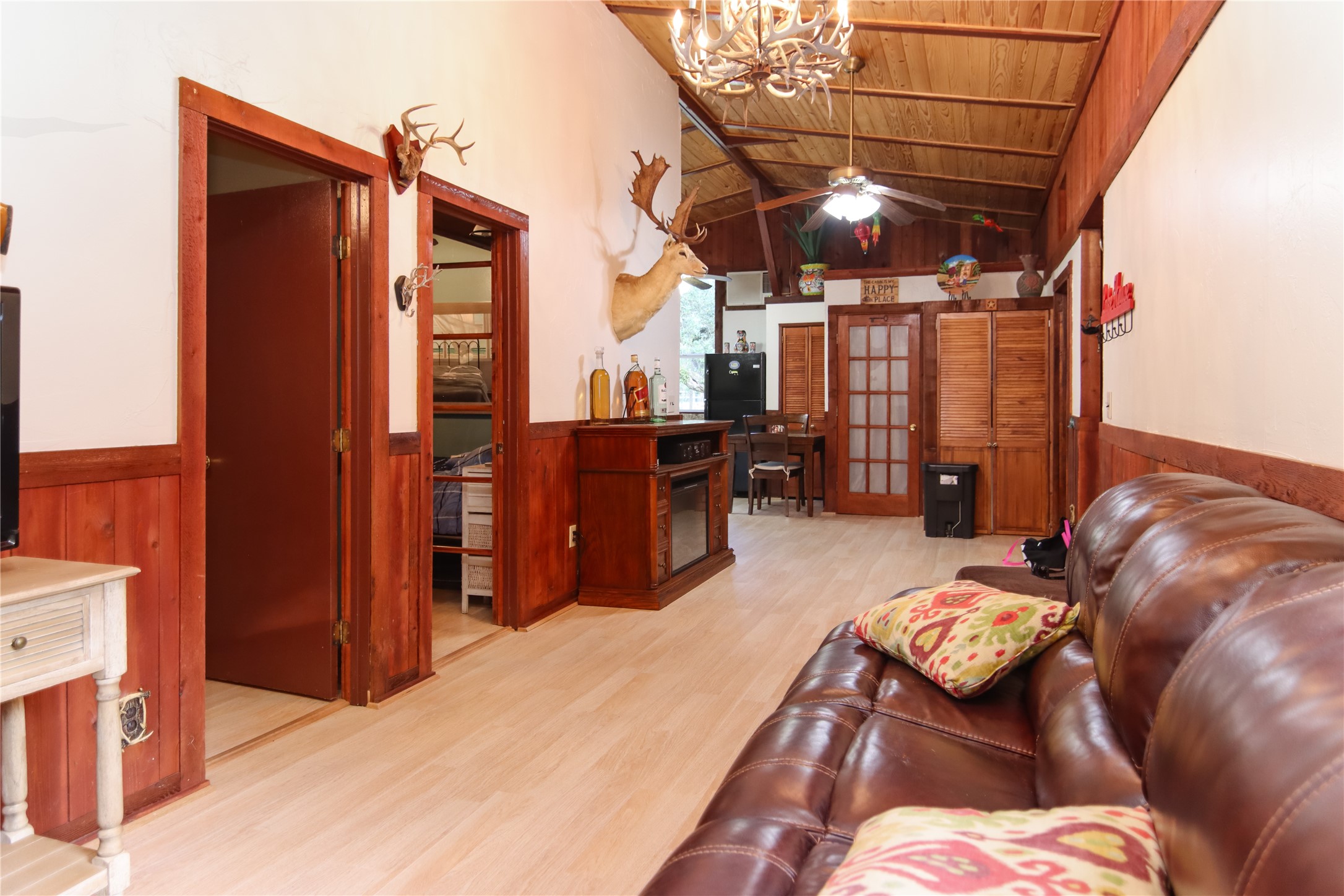 302 Bluebonnet Bend Sheridan, TX 77475 - Photo 18 of 29 a bed room with a bed and a chandelier