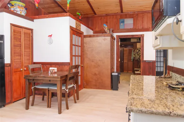 a kitchen with stainless steel appliances kitchen island granite countertop furniture a refrigerator and a sink