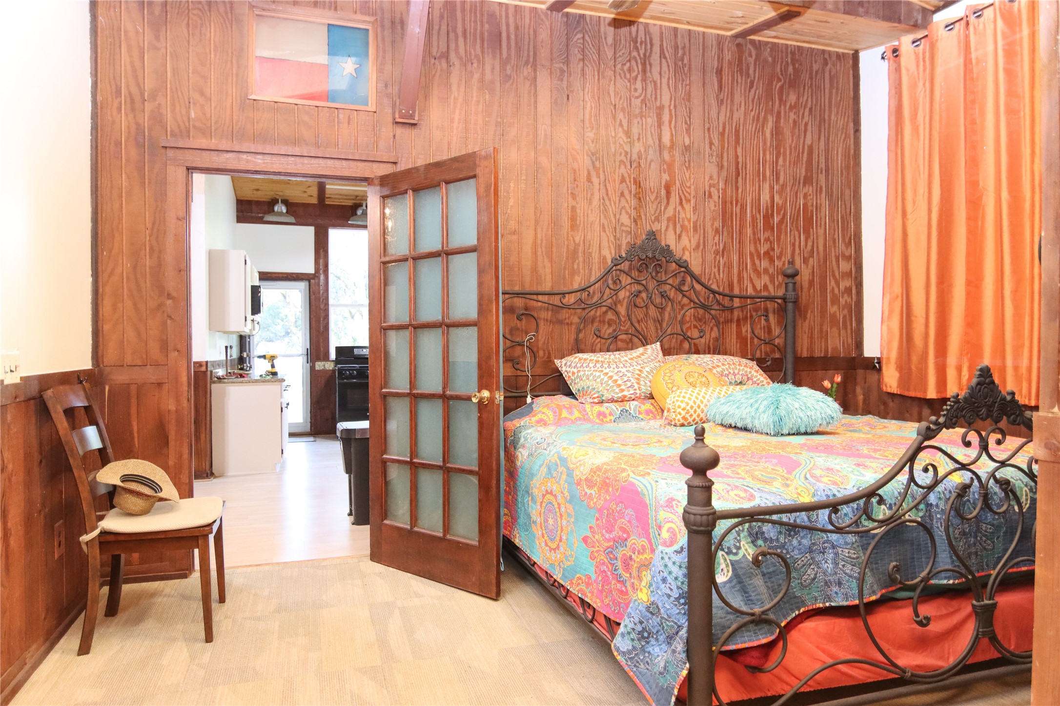 302 Bluebonnet Bend Sheridan, TX 77475 - Photo 25 of 29 a bedroom with a bed and a chandelier