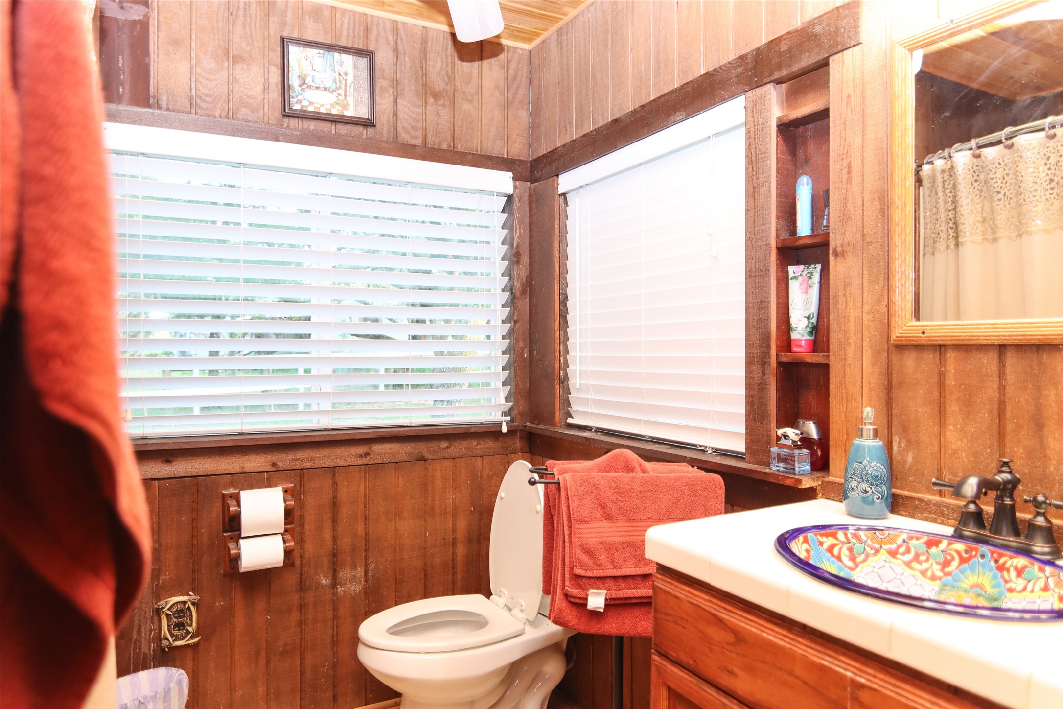 302 Bluebonnet Bend Sheridan, TX 77475 - Photo 26 of 29 a bathroom with a toilet a sink and mirror