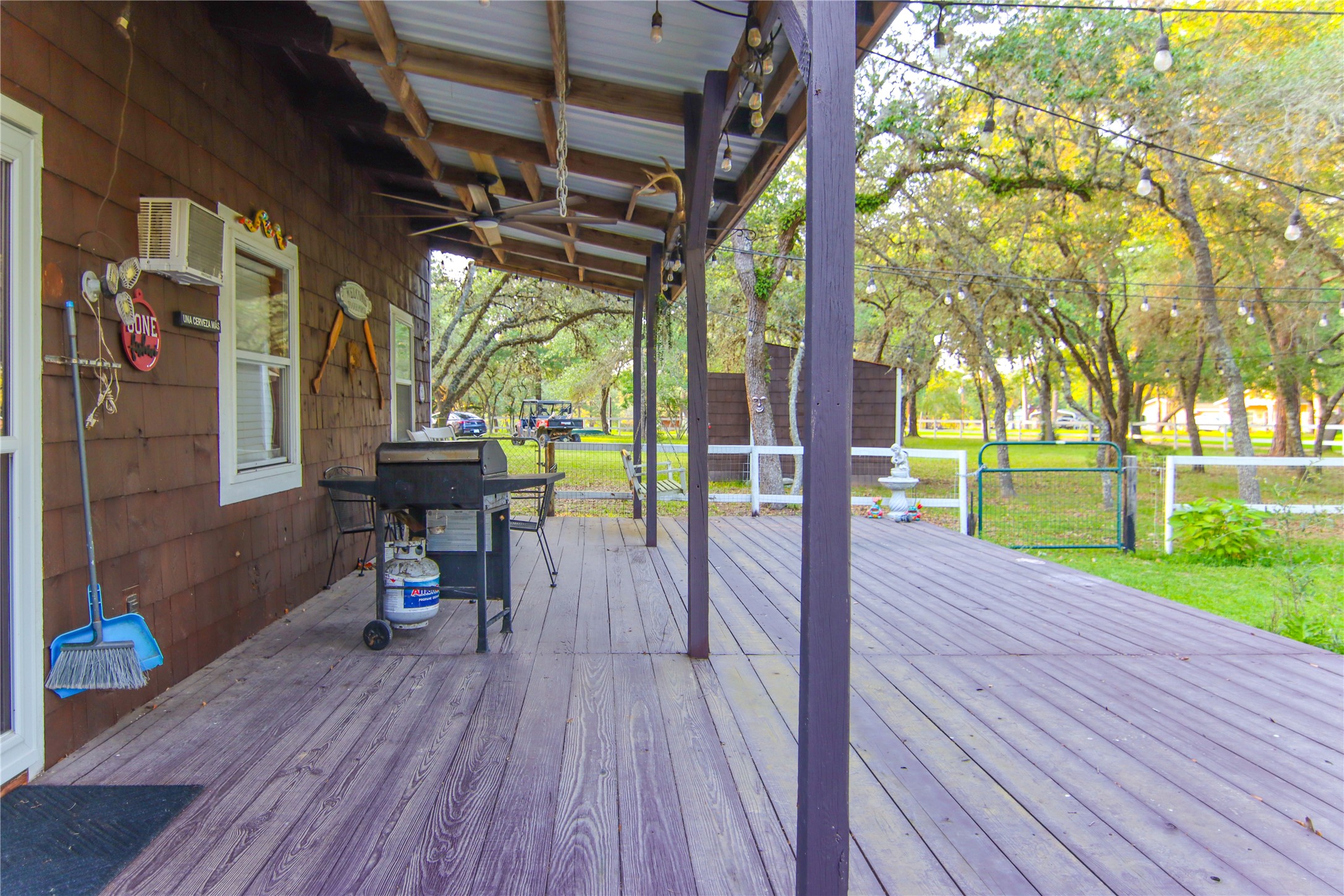 302 Bluebonnet Bend Sheridan, TX 77475 - Photo 29 of 29 a view of a patio with table and chairs and wooden floor