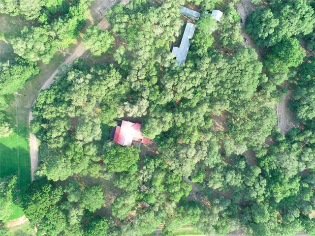 a backyard of a house with a table and chairs