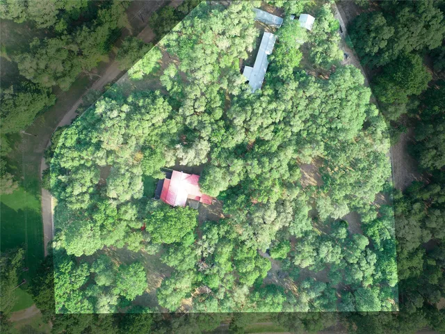 a backyard of a house with a yard and outdoor seating