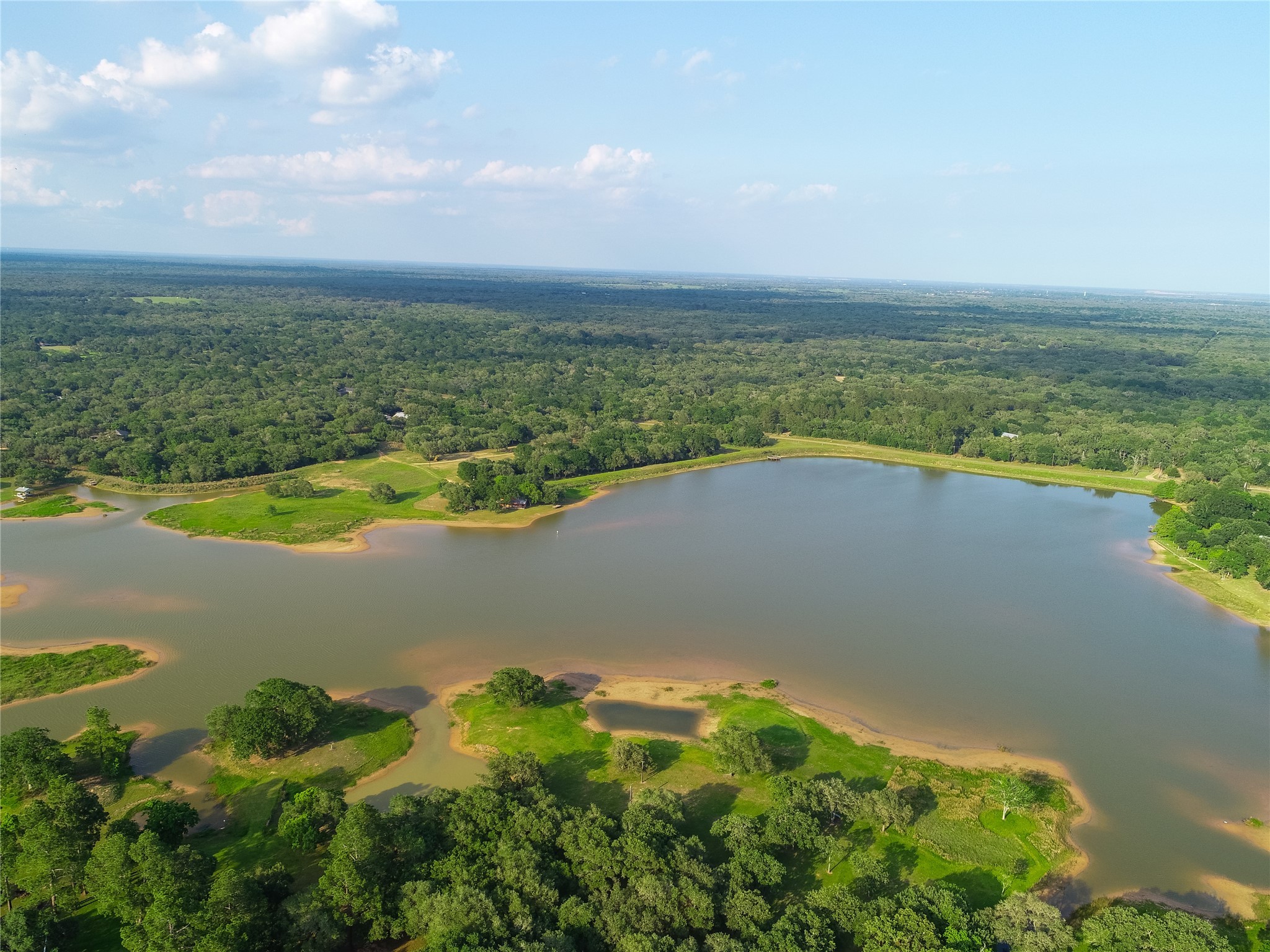 302 Bluebonnet Bend Sheridan, TX 77475 - Photo 8 of 29 a view of a lake with a yard