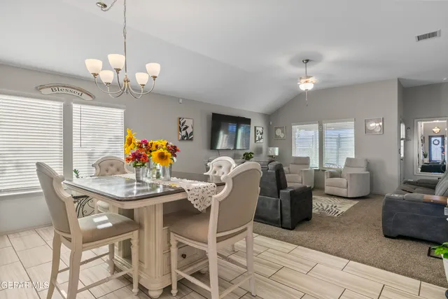 a view of a dining room with furniture and chandelier