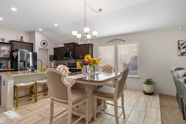 a view of a dining room with furniture and chandelier