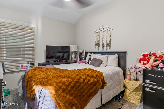 a bedroom with a bed and flat screen tv