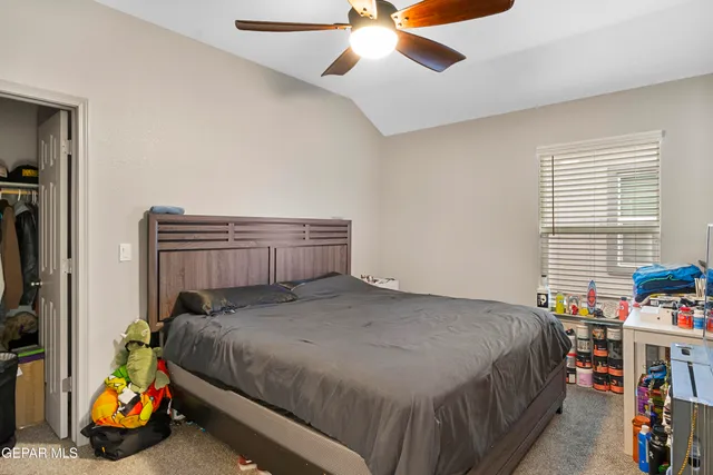 a bedroom with a bed and a window