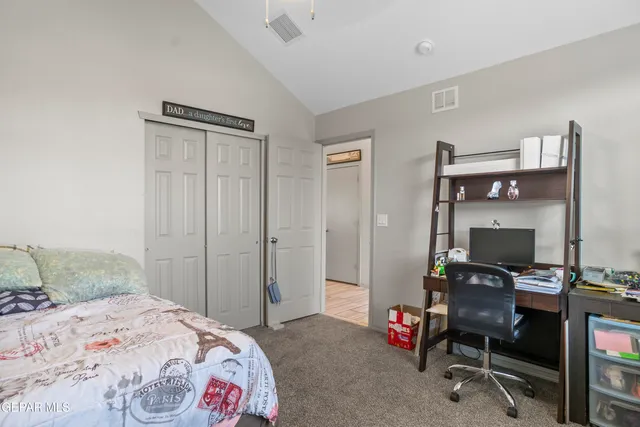 a bedroom with a bed and a desk