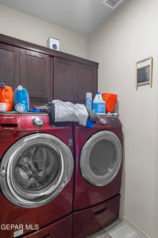 a utility room with sink washer and dryer
