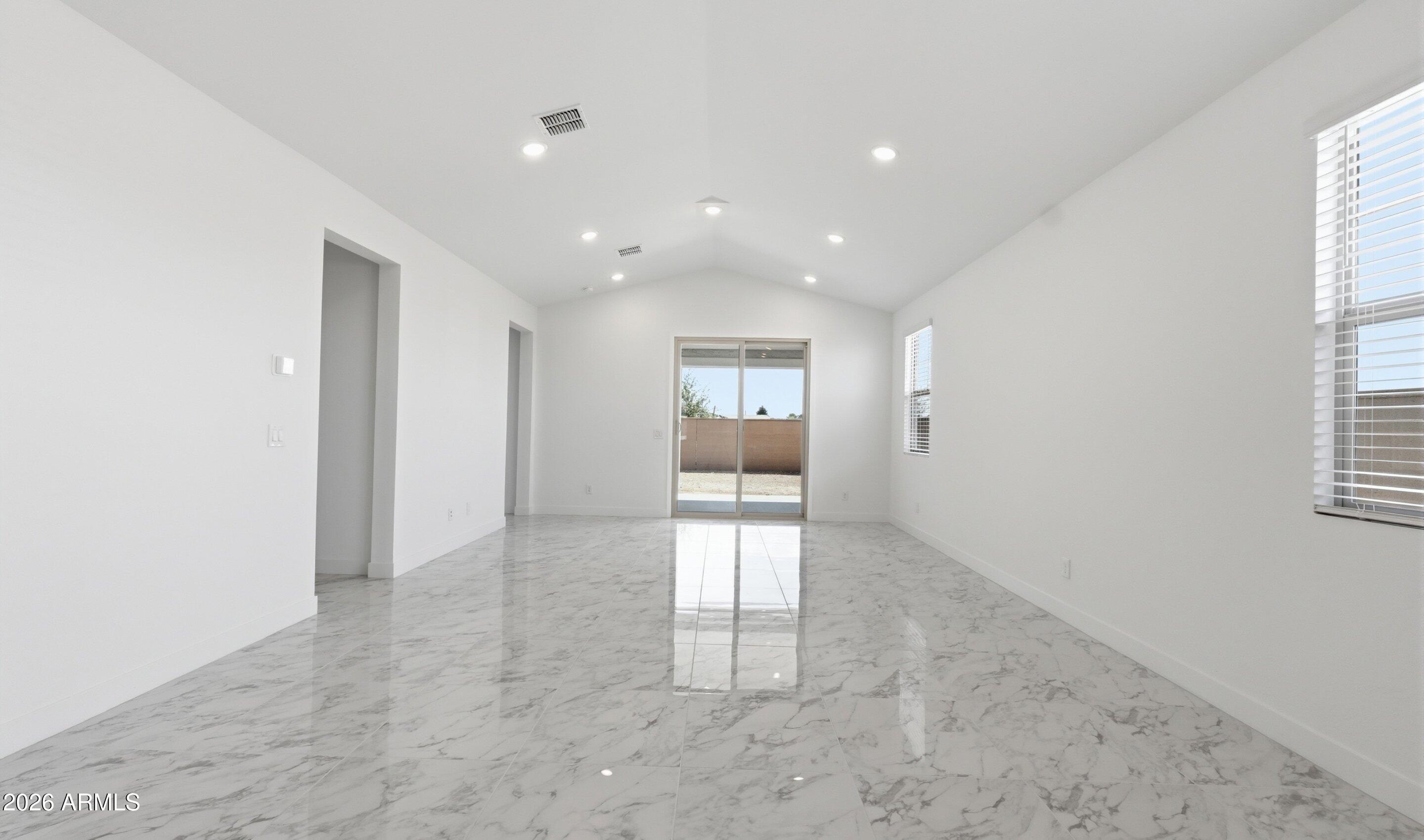 7779 West Sands Road Glendale, AZ 85303 - Photo 8 of 37 an empty room with windows and pillars in it