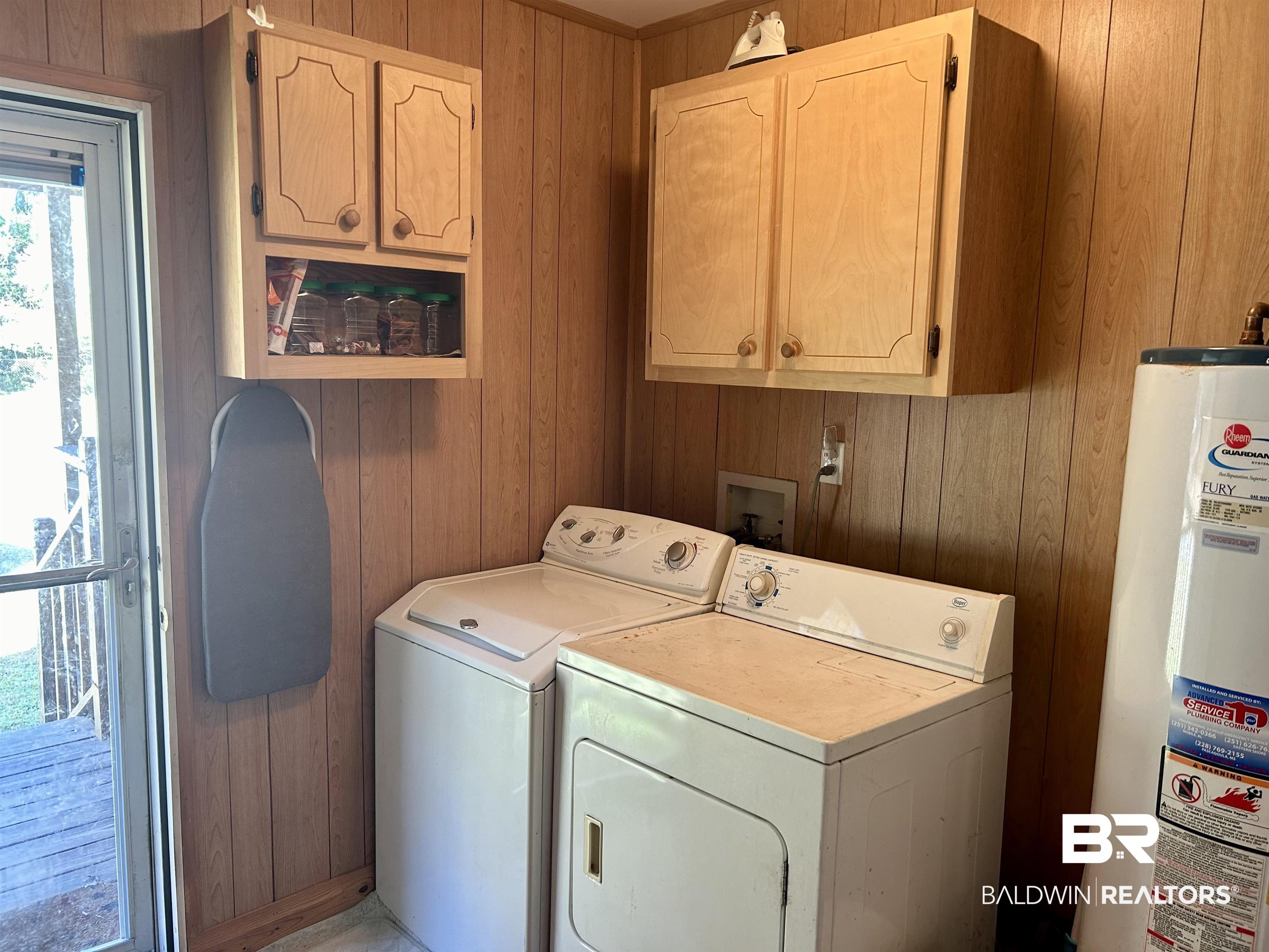 405 North Wasson Avenue Mobile, AL 36612 - Photo 13 of 26 Washroom featuring cabinets, gas water heater, and wooden walls