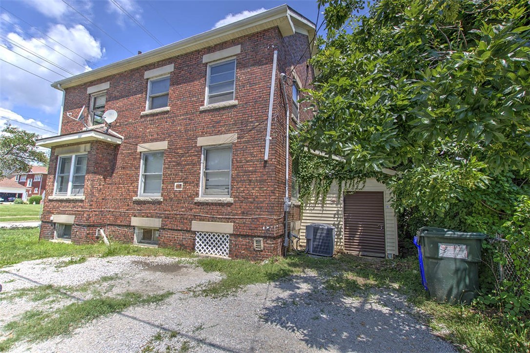 340 North Edward Street Decatur, IL 62522 - Photo 19 of 20 a brick building with a yard and a tree