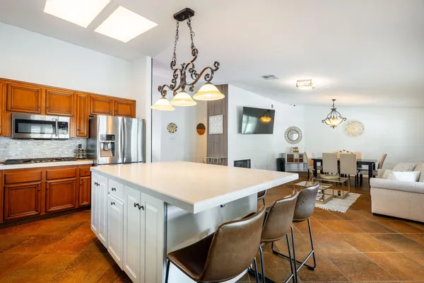 a large kitchen with a table and chairs