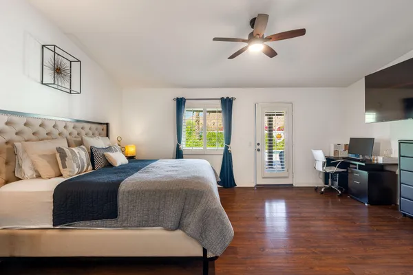 a bedroom with a bed and wooden floor