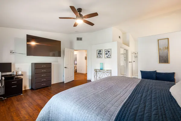 a bedroom with a bed and a flat screen tv
