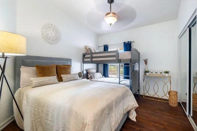 a bedroom with a bed and wooden floor