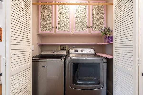 a view of washer and dryer sitting on a shelf