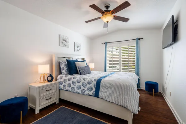 a bedroom with a bed and a chandelier