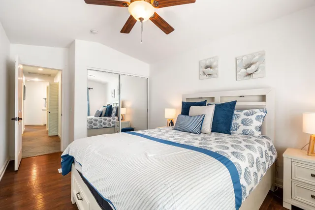 a bedroom with bed and wooden floor