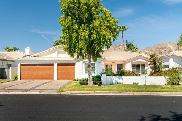a front view of a house with a yard and outdoor seating