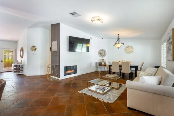 a living room with fireplace furniture and a flat screen tv