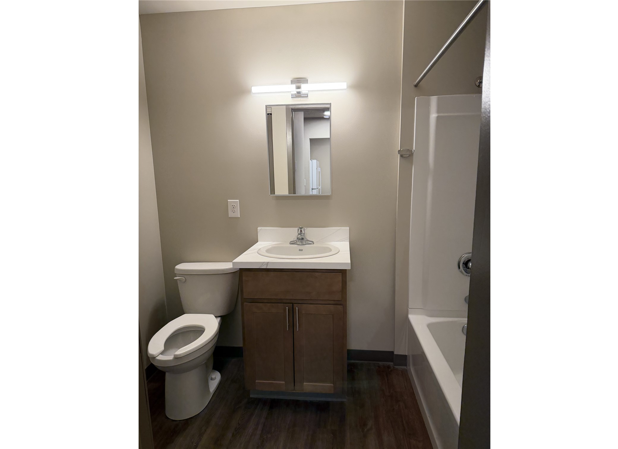 1700 Park Street Beatrice, NE 68310 - Photo 12 of 13 a bathroom with a toilet a sink and mirror