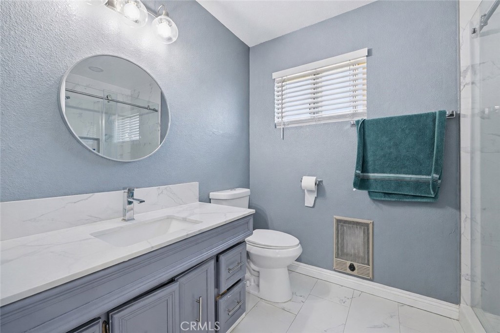 1032 South Farragut Street Ridgecrest, CA 93555 - Photo 17 of 22 a bathroom with a sink a toilet and a mirror