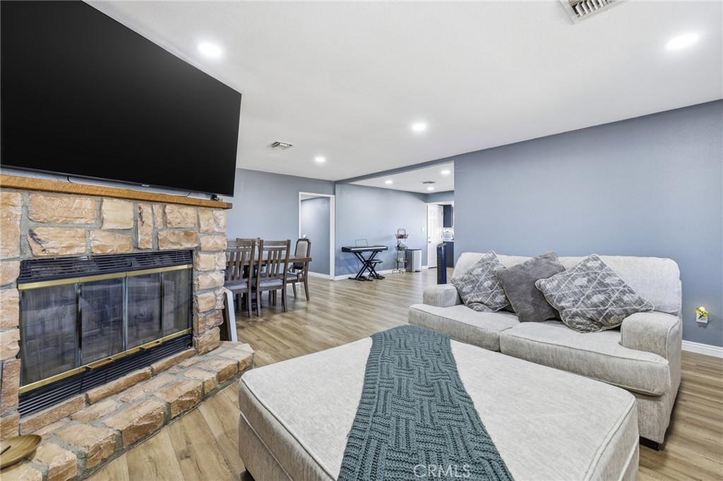 1032 South Farragut Street Ridgecrest, CA 93555 - Photo 6 of 22 a living room with furniture a flat screen tv and a floor to ceiling window