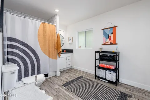 a view of a bedroom with wooden floor and shoes