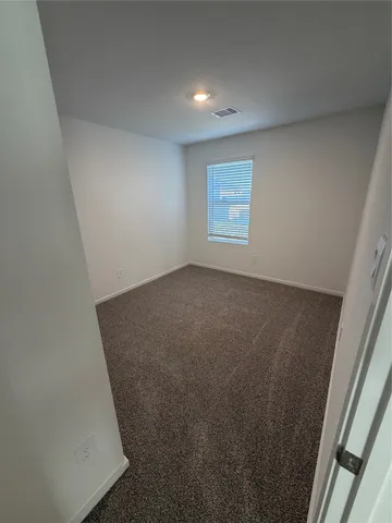 an empty room with windows and entrance