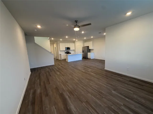 a view of a large kitchen with wooden floor and a counter top space