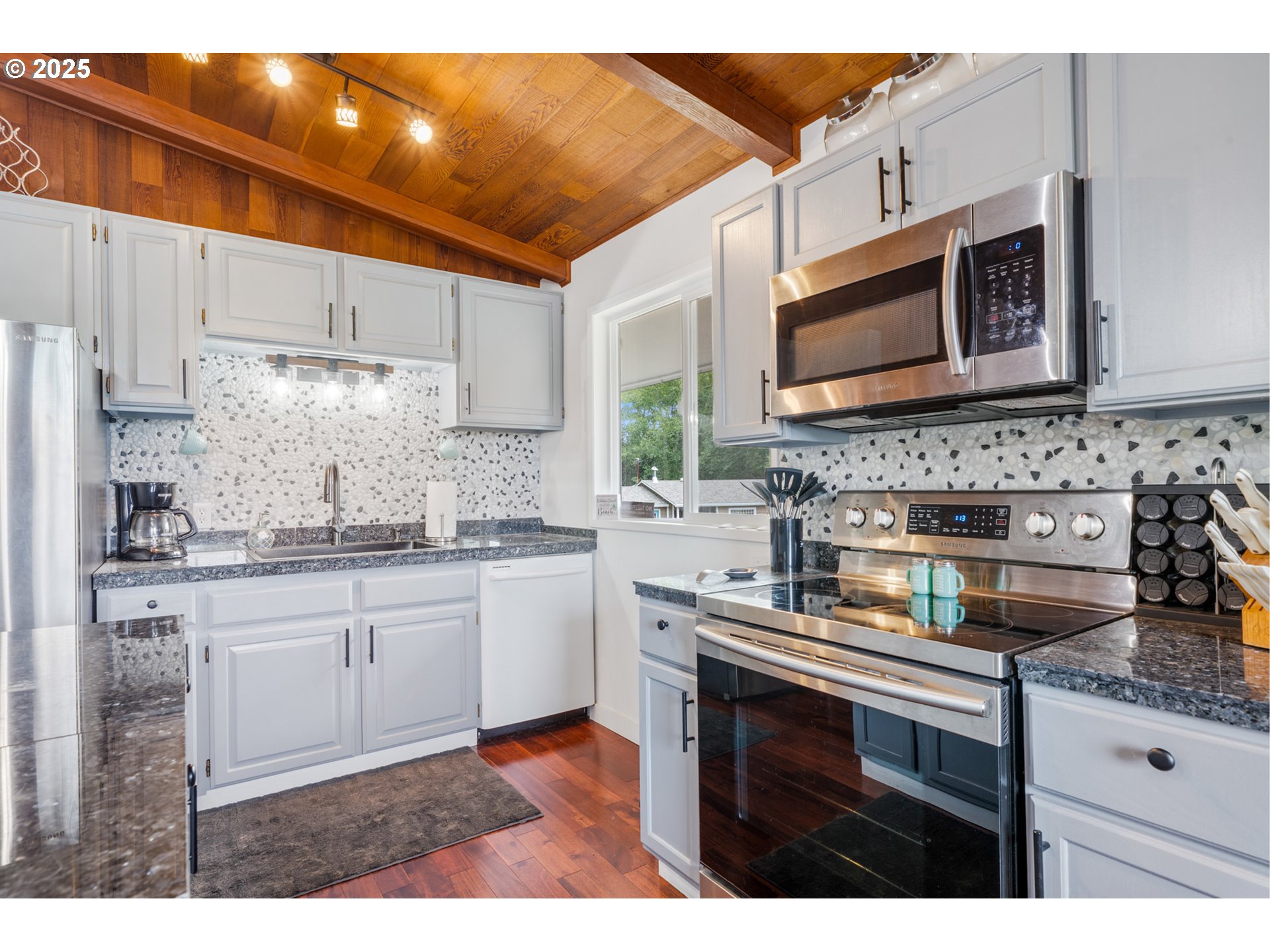 1960 Alder Cove Road West Netarts, OR 97141 - Photo 11 of 41 a kitchen with stainless steel appliances granite countertop a sink stove and microwave