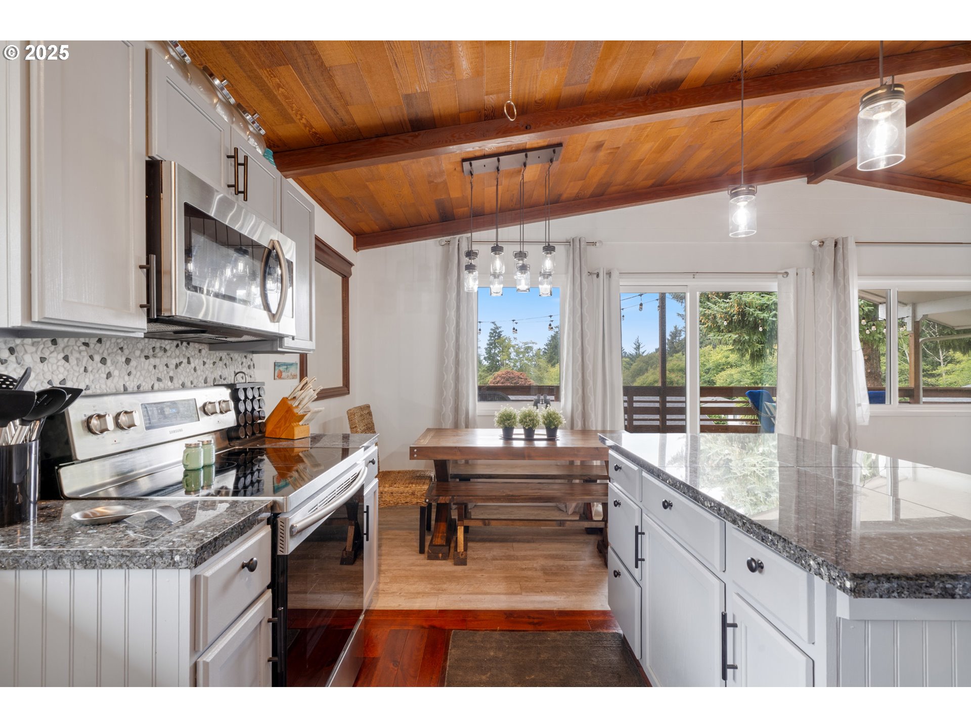 1960 Alder Cove Road West Netarts, OR 97141 - Photo 14 of 41 a kitchen with stainless steel appliances granite countertop a stove a sink and a refrigerator