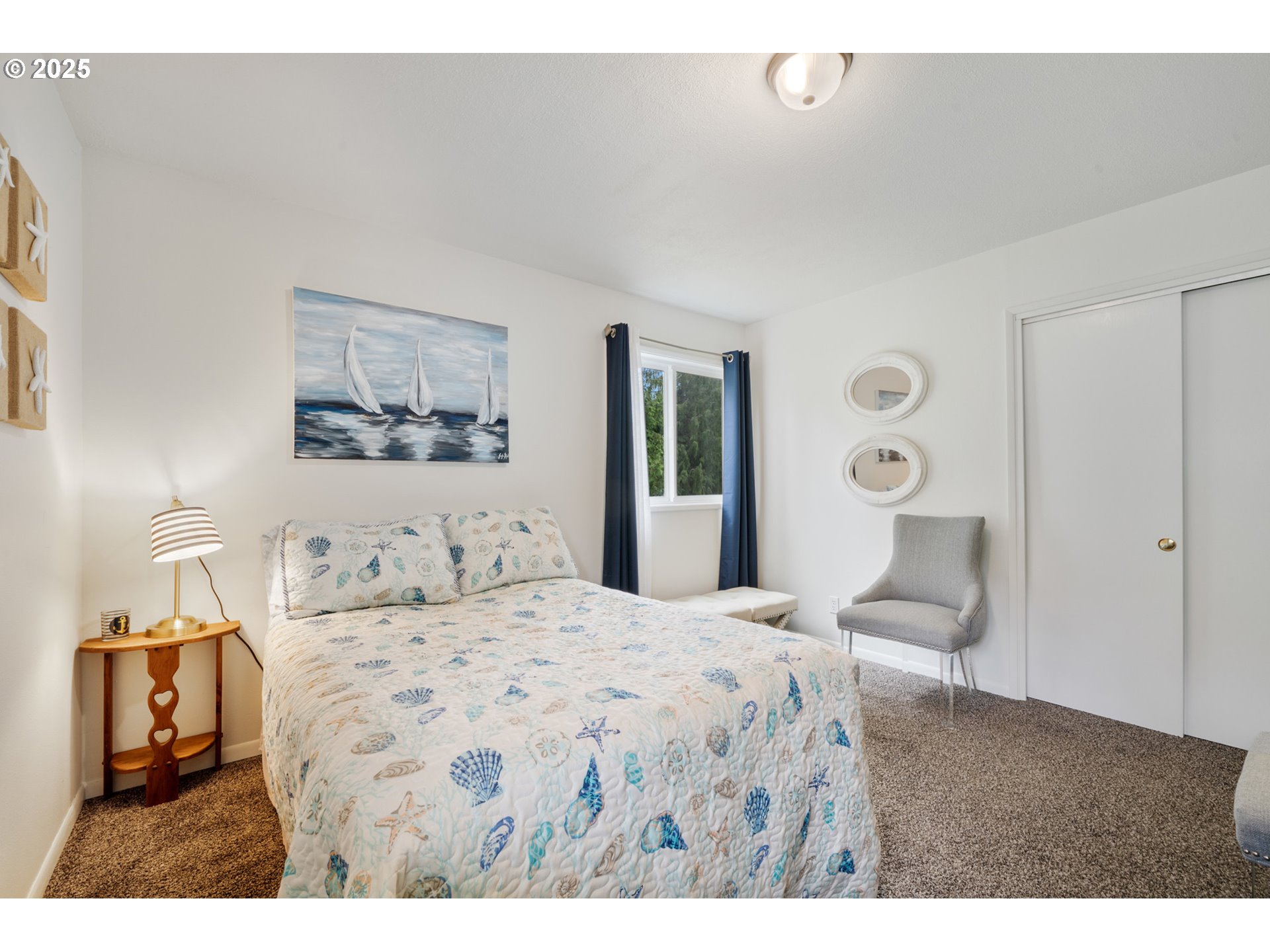 1960 Alder Cove Road West Netarts, OR 97141 - Photo 21 of 41 a bedroom with a bed and a painting on the wall
