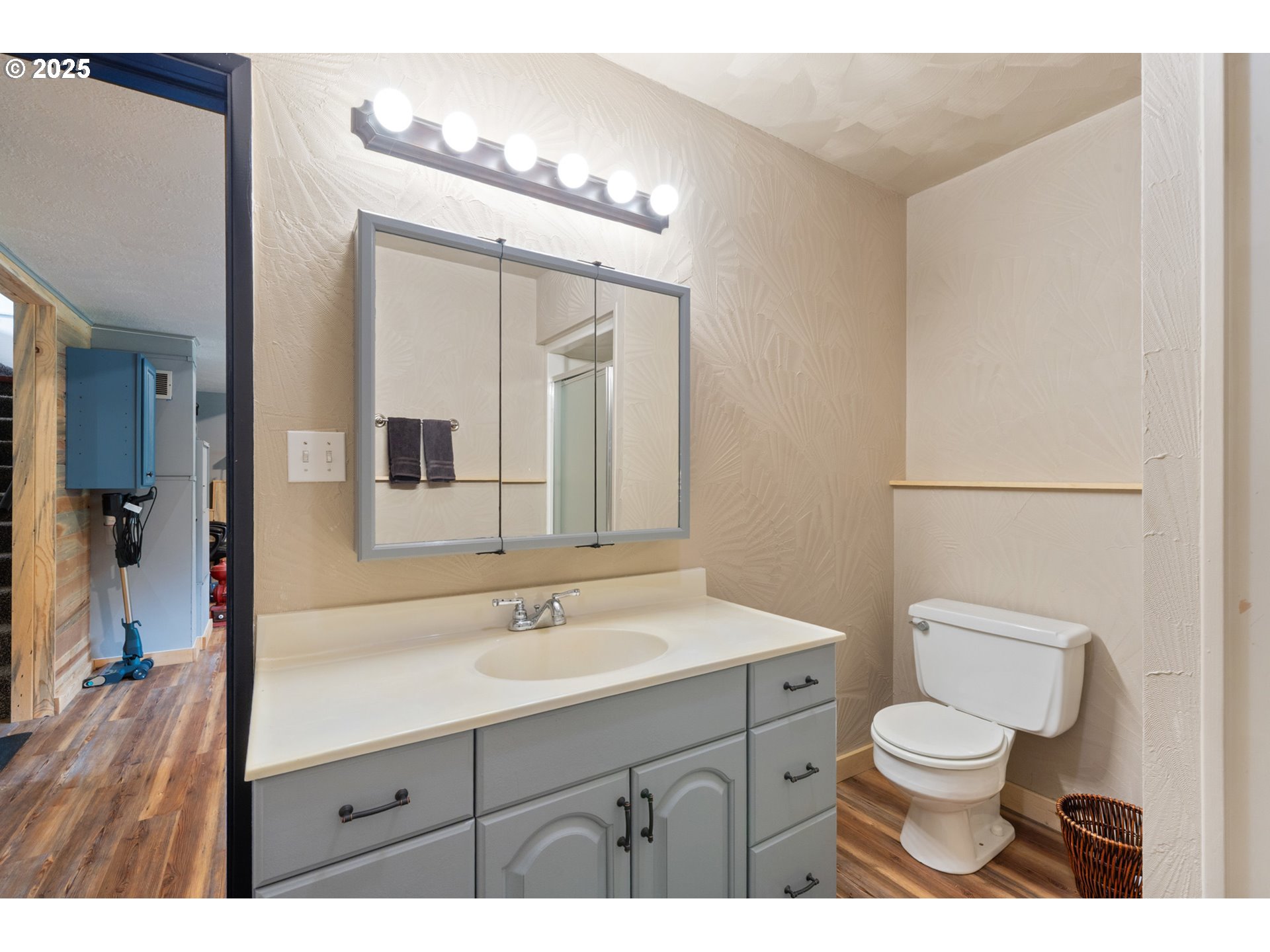 1960 Alder Cove Road West Netarts, OR 97141 - Photo 28 of 41 a bathroom with a toilet a sink a mirror and vanity