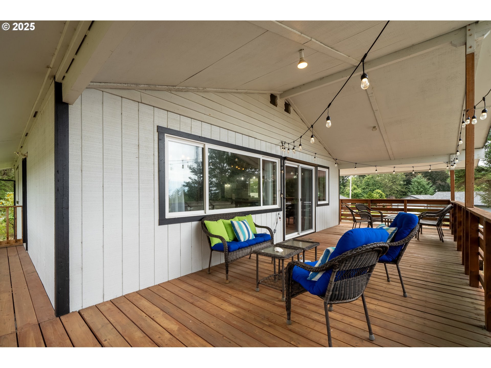1960 Alder Cove Road West Netarts, OR 97141 - Photo 32 of 41 a view of a patio with a dining table and chairs with wooden floor