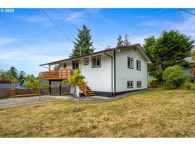 a view of a house with wooden fence