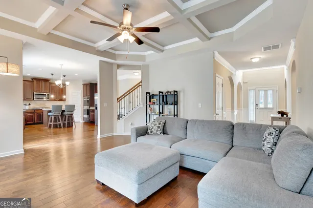 a kitchen with stainless steel appliances granite countertop wooden cabinets a stove a sink and a refrigerator