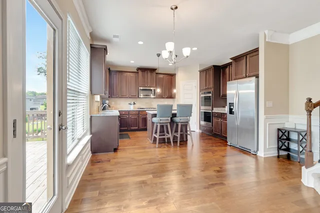 a kitchen with a sink stove and wooden cabinets