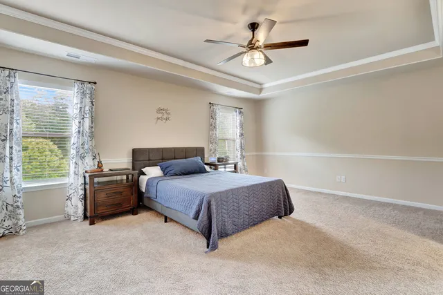 an empty room with fan and windows