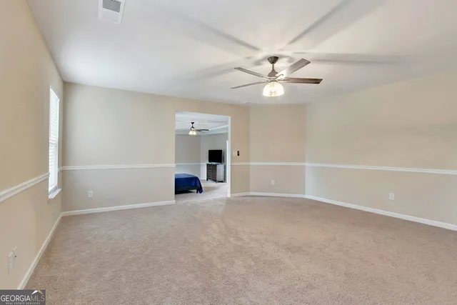 a spacious bathroom with double sink and a mirror
