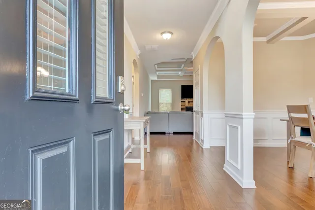 a view of a dining room with furniture and chandelier